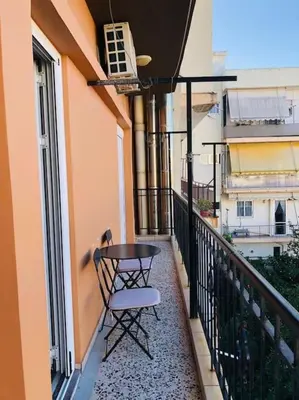 a balcony with a table and a chair on it at Ariadni's apartment 2 in Chania Town