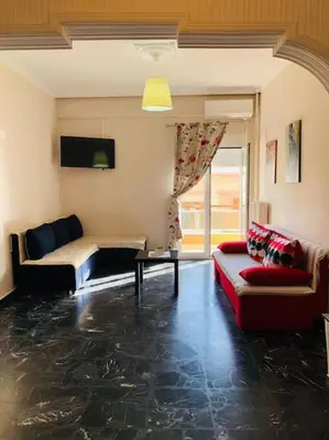 a living room with two couches and a table at Ariadni's apartment 2 in Chania Town