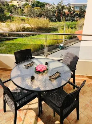 a glass table and chairs on a balcony with a view at Ariadni's apartment 1 in Chania Town