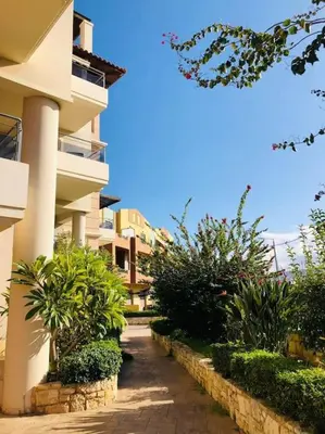 a walkway in front of a building with plants at Ariadni's apartment 1 in Chania Town