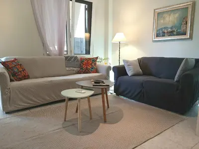 a living room with two couches and a coffee table at Capt73134 in Chania Town