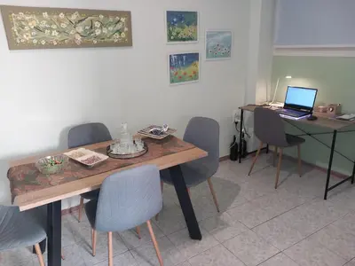 a room with a table and chairs with a laptop on it at Capt73134 in Chania Town