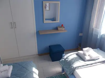 a blue room with a bed and a mirror at Capt73134 in Chania Town