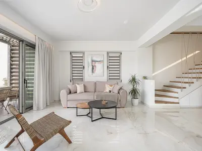 a living room with a couch and a table at Fivi Villa, with Heated Pool & SeaViews, By ThinkVilla in Tavronitis
