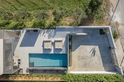 an overhead view of a swimming pool next to a house at Fivi Villa, with Heated Pool & SeaViews, By ThinkVilla in Tavronitis