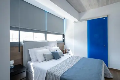 a bedroom with a large bed with white pillows at Disegno Residences in Chania Town