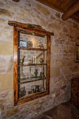 a glass shelf in a stone wall with items on it at Metochi Traditional House in Chania Town