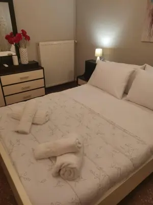 a bedroom with a bed with towels on it at Dimitras residence in Chania Town