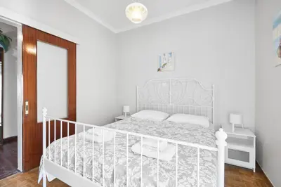 a white bedroom with a white bed in a room at Angelina House in Chania Town