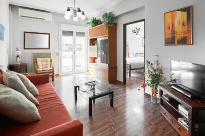 a living room with a couch and a tv at Angelina House in Chania Town