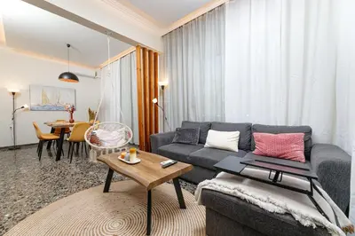 a living room with a couch and a table at Dk central apartment in the heart of the city in Chania Town