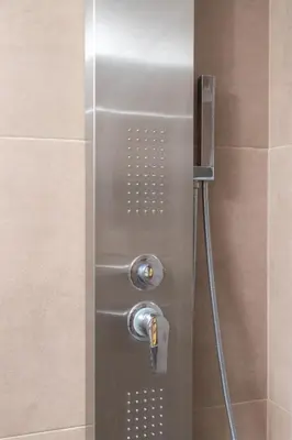 a shower with a glass door with a shower head at Dk central apartment in the heart of the city in Chania Town