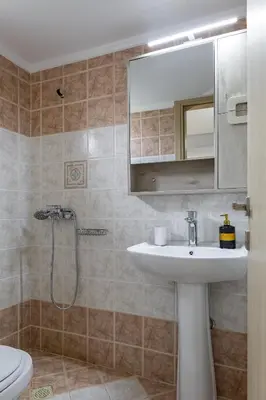 a bathroom with a sink and a shower at Villa panagiotis in Kissamos