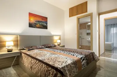 a bedroom with a large bed and a bathroom at Villa panagiotis in Kissamos