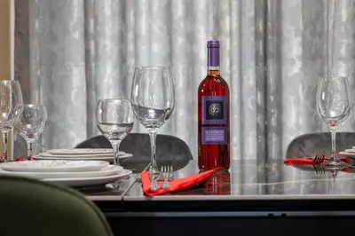a bottle of wine sitting on a table with wine glasses at Villa panagiotis in Kissamos