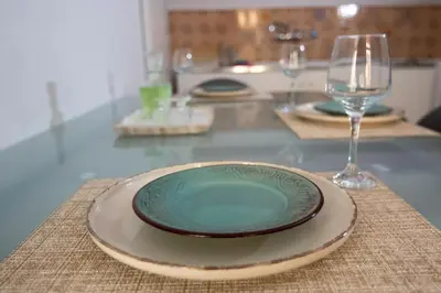a plate and a wine glass on a table at Casa Bollani - Old Town Chania House in Chania Town