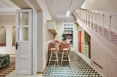 a hallway with stools and a table in a house at Elyn House in Chania Town