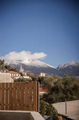 a view of a mountain with a fence and mountains at Elirion Luxury Home in Kamária