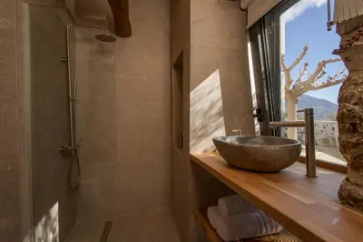 a bathroom with a sink and a glass shower at Elirion Luxury Home in Kamária