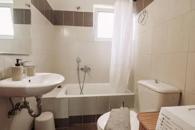 a bathroom with a sink and a toilet and a tub at Summer Blue Apartments Chania in Chania Town