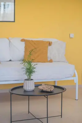 a living room with a white couch and a table at Summer Blue Apartments Chania in Chania Town