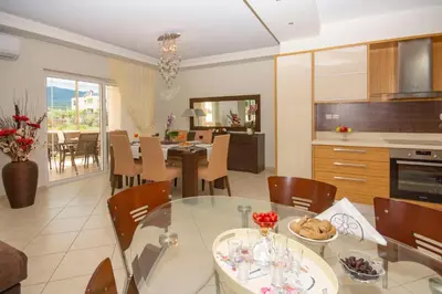 a kitchen and dining room with a table and chairs at Jasmine House Kissamos in Kissamos