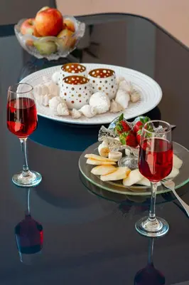 two glasses of wine and a plate of food on a table at Jasmine House Kissamos in Kissamos