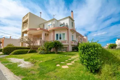 a large pink house on a grassy hill at Jasmine House Kissamos in Kissamos