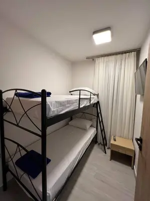 a room with two bunk beds and a television at CARA Creta Home in Kolymvari