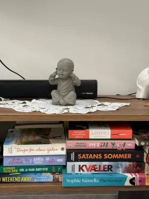 a doll sitting on top of a pile of books at CARA Creta Home in Kolymvari
