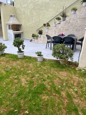 a patio with a table and chairs and a fireplace at CARA Creta Home in Kolymvari