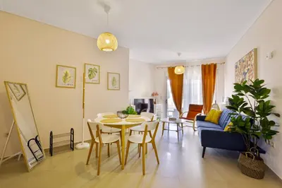 a living room with a table and a blue couch at Lazaretta apartment 2 in Chania Town