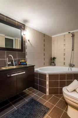 a bathroom with a tub and a toilet and a sink at Emma Hills Villa in Korakiaí