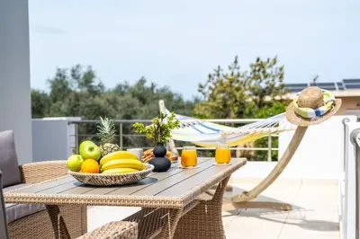 a table with a bowl of fruit on a patio at Emma Hills Villa in Korakiaí