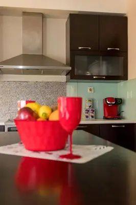a bowl of fruit and a wine glass on a table in a kitchen at Arias'-Welcoming Guest House in Kounoupidhianá