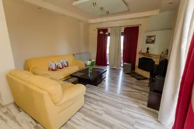 a living room with a couch and a table at Arias'-Welcoming Guest House in Kounoupidhianá