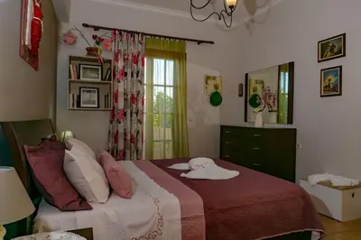 a bedroom with a bed with pillows and a window at Seize the seas in Kalamaki Chanion