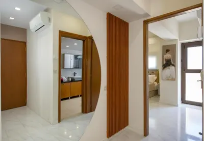 a hallway with a mirror and a room with a kitchen at Aretousa Home in Chania Town