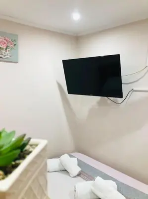 a room with a bed with a tv on the wall at Ariadni's apartment 3 in Chania Town