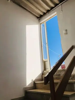 a staircase in a building with a large window at Ariadni's apartment 3 in Chania Town