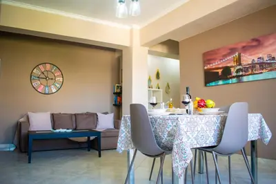 a living room with a table and a couch at Eva's Residence, Family Apartment in Chania Town