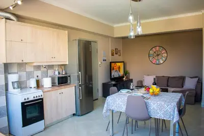 a kitchen and living room with a table and chairs at Eva's Residence, Family Apartment in Chania Town