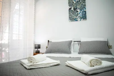 a bedroom with a bed with towels on it at Eva's Residence, Family Apartment in Chania Town