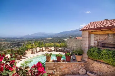 a villa with a swimming pool and a house at Samonas - 5 maisonettes with breathtaking views in Chania Town