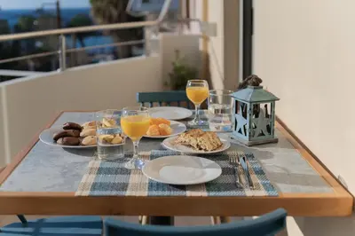 a table with plates of food and glasses of orange juice at Dejaview cozy apartment by 8essentially in Chania Town