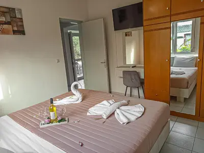 a bedroom with a bed with a bottle of wine at Lampros house in the countryside in Chania Town