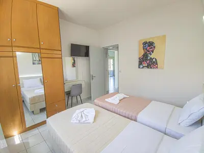 a hotel room with two beds and a bathroom at Lampros house in the countryside in Chania Town