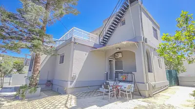 a small white house with a table and chairs at Lampros house in the countryside in Chania Town