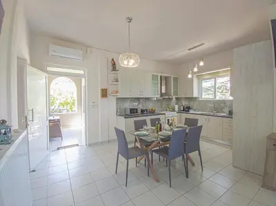 a kitchen and dining room with a table and chairs at Lampros house in the countryside in Chania Town