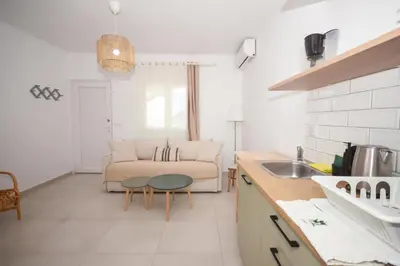 a kitchen and living room with a couch and a table at Elia Apartments in Falasarna